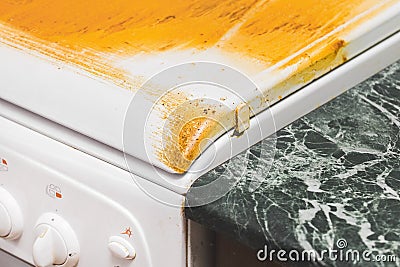 Dirty sticky coating on a gas stove. Home cleaning in the kitchen Stock Photo