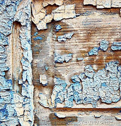 Dirty stripped paint in the blue wood door and rusty nail Stock Photo