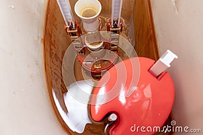 Dirty unhygienic rusty and calcified flush tank of toilet with limescale and rust stains and scum need to be cleaned and repared Stock Photo