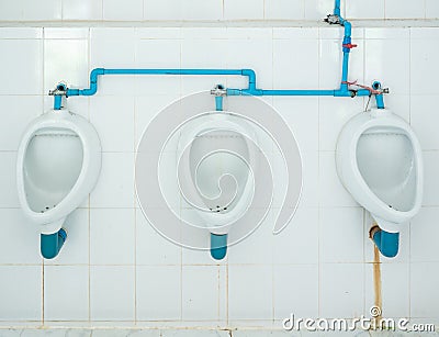 Dirty urinal row with the stain. Stock Photo