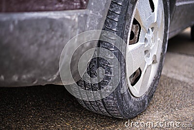 Dirty wheel of a car tire due to salt Stock Photo