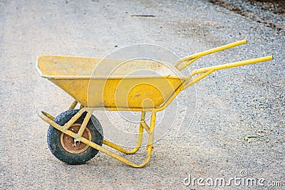 Dirty yellow cart for construction Stock Photo