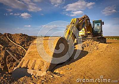 Dirty yellow excavator Stock Photo