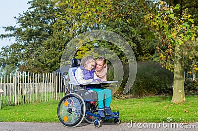 Disabled girl in a wheelchair relaxing outside Stock Photo