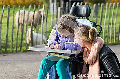 Disabled girl in a wheelchair relaxing outside Stock Photo