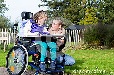 Disabled girl in a wheelchair relaxing outside Stock Photo