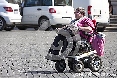 Disability woman with little car (wheelchair) Editorial Stock Photo