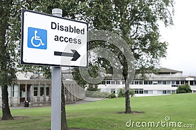 Disabled access sign for wheelchair users directional arrow at school Stock Photo
