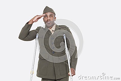 Disabled African American military officer in uniform salutes over gray background Stock Photo