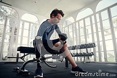 Disabled athlete doing bicep curls in the gym preparing for the Paralympics Stock Photo