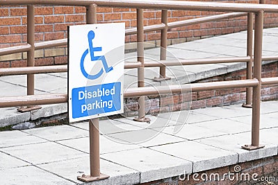 Disabled blue sign and ramp rails accessible entrance Stock Photo