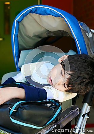Disabled five year old boy in wheelchair Stock Photo