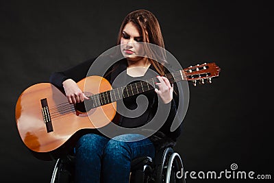 Disabled girl playing guitar. Stock Photo