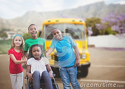 Disabled girl in wheelchair with friends in front of school bus Stock Photo