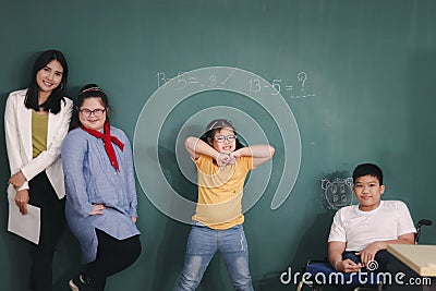 Disabled kids classroom, school boy on wheelchair and down syndrome girls learning and having fun during study at school with Stock Photo