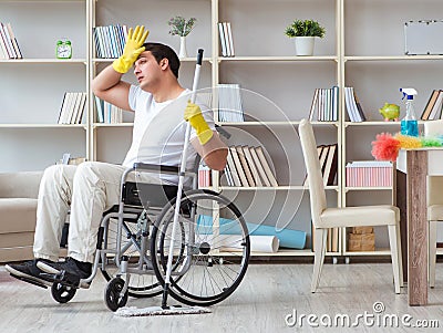 Disabled man cleaning floor at home Stock Photo