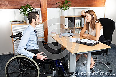 Disabled man having a business meeting with a businesswoman Stock Photo