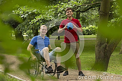 Disabled man playing sport with friend Stock Photo