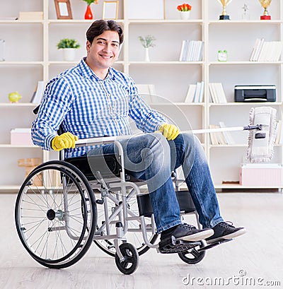Disabled man on wheelchair cleaning home Stock Photo