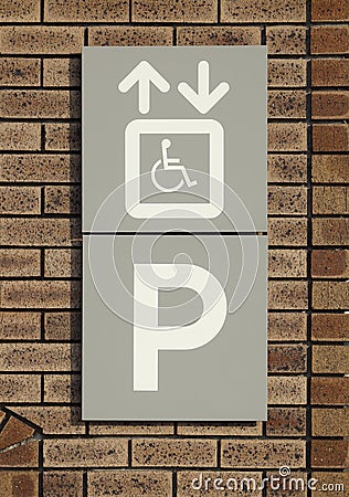 Disabled parking sign on brick wall Stock Photo