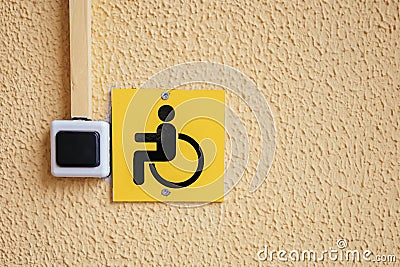 Wheelchair and handicapped accessible entrance sign. Staff call button for people with disabilities at the entrance to a Stock Photo