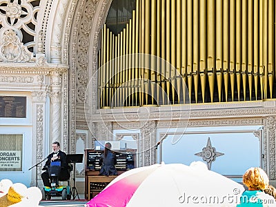 Disabled person sitting on wheelchair sings on stage with organ Editorial Stock Photo