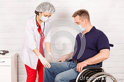 A disabled person in a wheelchair at a reception at a female rehabilitation doctor Stock Photo