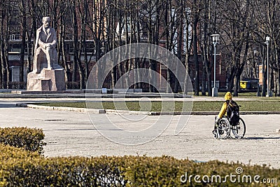 Disabled person in wheelchair sightseeing in the park. Handicapped woman on the walk outdoors Editorial Stock Photo