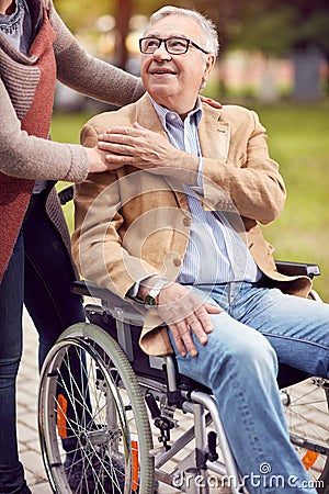 Disabled positive elderly man in wheelchair Stock Photo