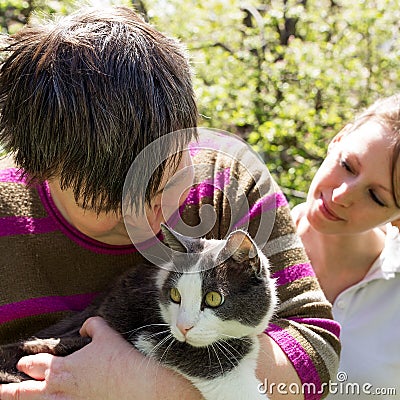 Disabled woman cuddles a cat Stock Photo