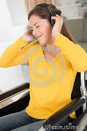 disabled woman in rapture listening to headphones Stock Photo