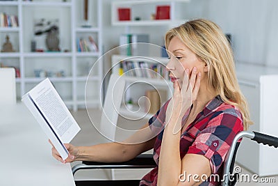 Disabled woman reading novel Stock Photo