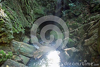 River goes underground into a sinkhole Stock Photo