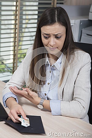 Disappointed business woman draws money from an envelope Stock Photo