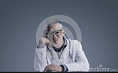 Disappointed doctor leaning on his arm Stock Photo