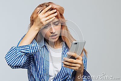 Disappointed female received bad news, looking at phone. Emotions and awkwardness gestures,Epic fail, facepalm Stock Photo