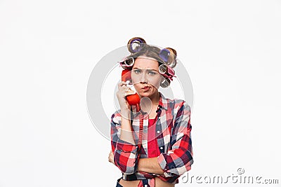 Disappointed housewife with curlers in hair Stock Photo