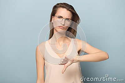 Disappointed woman in glasses show thumb down feel dissatisfied Stock Photo