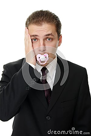 Disappointed young businessman with pacifier Stock Photo