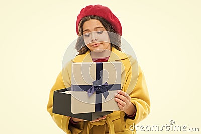 Disappointing purchase. Child stylish hold open gift box. Girl cute little lady coat and beret throws out gift. Spring Stock Photo