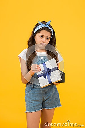 Disappointment concept. Not what I wanted. Kid love birthday gift. Feeling sad bad gift. Surprise present box. Kid girl Stock Photo