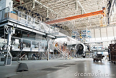 Disassembled airplane for repair and modernization in jet hangar Editorial Stock Photo