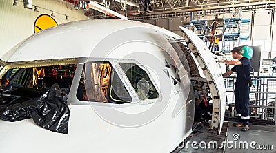 Disassembled airplane for repair and modernization in jet hangar Editorial Stock Photo