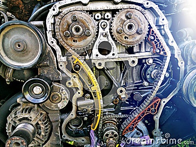 Disassembled car engine during repair. A close-up of an exploded view of the engine chain, gears and tensioners during repair and Stock Photo