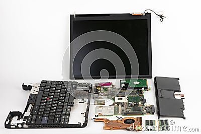 Disassembled laptop, basic components of notebook, screen, keyboard, processor, motherboard, internal hard disk drive, CPU fan Stock Photo