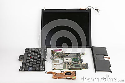 Disassembled laptop, basic components of notebook, screen, keyboard, processor, motherboard, touchpad , CPU fan Stock Photo