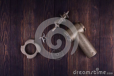Disassembled meat grinder on wooden table Stock Photo