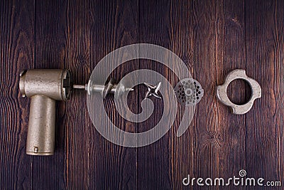 Disassembled meat grinder on wooden table Stock Photo