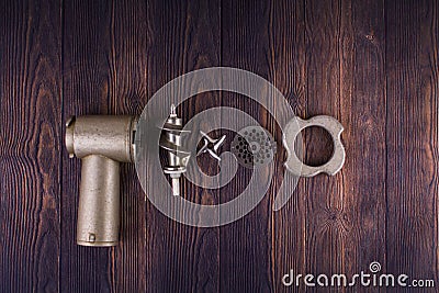 Disassembled meat grinder on wooden table Stock Photo