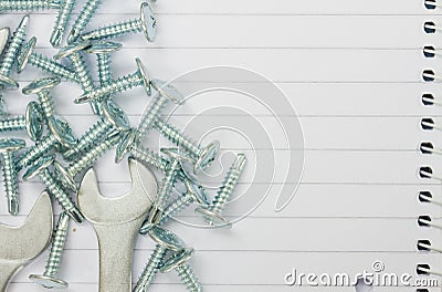 Disassembled screws and wrenches on paper Stock Photo